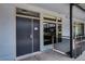 Modern building hallway with a unit entrance, windows with views, and contemporary design elements at 8925 W Flamingo Rd # 228, Las Vegas, NV 89147