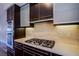 Close-up of a kitchen featuring stainless steel oven and gas stovetop with a stone backsplash at 8925 W Flamingo Rd # 228, Las Vegas, NV 89147