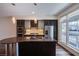 Modern kitchen featuring stainless steel appliances, a granite island, and bright natural light at 8925 W Flamingo Rd # 228, Las Vegas, NV 89147
