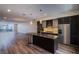 Modern open-concept kitchen featuring stainless steel appliances, a stone backsplash, and an island at 8925 W Flamingo Rd # 228, Las Vegas, NV 89147