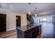 Open-concept kitchen featuring an island with a sink and modern lighting fixtures at 8925 W Flamingo Rd # 228, Las Vegas, NV 89147