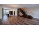 Modern living room featuring wood floors, an open layout, statement lighting, and a staircase at 8925 W Flamingo Rd # 228, Las Vegas, NV 89147