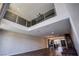 Modern living room featuring high ceilings, hardwood floors, and a loft area with glass railings at 8925 W Flamingo Rd # 228, Las Vegas, NV 89147