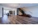 Open living space with hardwood floors, modern staircase, and kitchen view at 8925 W Flamingo Rd # 228, Las Vegas, NV 89147