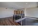 Open loft featuring modern railing, wood-look floors, and contemporary design at 8925 W Flamingo Rd # 228, Las Vegas, NV 89147