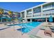 Resort-style community pool with lounge chairs, palm trees, and cabanas at 8925 W Flamingo Rd # 228, Las Vegas, NV 89147