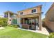 Inviting backyard with outdoor seating, a patio, and a well-maintained lawn at 8977 Sweet Chestnut Ln, Las Vegas, NV 89178