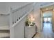 Light and bright entryway features wood look floors and a staircase with white banister at 8977 Sweet Chestnut Ln, Las Vegas, NV 89178