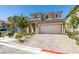 Two-story home featuring a two-car garage and brick paver driveway at 8977 Sweet Chestnut Ln, Las Vegas, NV 89178