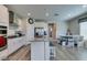Kitchen featuring an island with seating, stainless steel appliances, and white cabinets at 8977 Sweet Chestnut Ln, Las Vegas, NV 89178