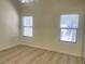 Well-lit bedroom with wood-look flooring and large windows at 8985 S Durango Dr # 2043, Las Vegas, NV 89113