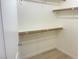 Empty walk-in closet with wood shelves and baseboards for efficient storage at 8985 S Durango Dr # 2043, Las Vegas, NV 89113