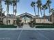 Elegant clubhouse entrance framed by lush landscaping and towering palm trees in a gated community at 8985 S Durango Dr # 2043, Las Vegas, NV 89113