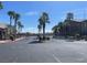 Welcoming entry gate to a well-maintained community with mature landscaping and palm trees at 8985 S Durango Dr # 2043, Las Vegas, NV 89113