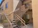 Tan two-story home featuring stairs to the second floor with well-maintained landscaping at 8985 S Durango Dr # 2043, Las Vegas, NV 89113