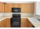 Functional kitchen featuring wood cabinets, essential appliances, and a double sink basin at 8985 S Durango Dr # 2043, Las Vegas, NV 89113