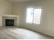 Living room features wood-look floors, a fireplace, and a large window bringing in natural light at 8985 S Durango Dr # 2043, Las Vegas, NV 89113