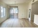 Bright living room featuring wood-look floors, a sliding glass door, and natural light at 8985 S Durango Dr # 2043, Las Vegas, NV 89113