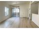 Bright living room featuring wood-look floors, a sliding glass door, and natural light at 8985 S Durango Dr # 2043, Las Vegas, NV 89113
