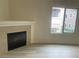 Living room features wood-look floors, a fireplace, and a large window bringing in natural light at 8985 S Durango Dr # 2043, Las Vegas, NV 89113