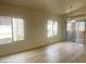 Bright living room featuring wood-look floors and lots of natural light through the two large windows at 8985 S Durango Dr # 2043, Las Vegas, NV 89113