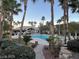 Beautiful community pool framed by lush landscaping and towering palm trees, creating a tranquil oasis at 8985 S Durango Dr # 2043, Las Vegas, NV 89113