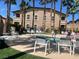 Inviting community hot tub surrounded by lounge chairs and mature palm trees on a sunny day at 8985 S Durango Dr # 2043, Las Vegas, NV 89113