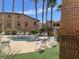 Inviting community hot tub surrounded by lounge chairs and mature palm trees on a sunny day at 8985 S Durango Dr # 2043, Las Vegas, NV 89113