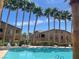 Community pool surrounded by palm trees offering a resort-like experience at 8985 S Durango Dr # 2043, Las Vegas, NV 89113