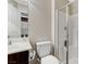 Modern bathroom with a glass-doored shower, white toilet and dark brown vanity at 9050 W Tropicana Ave # 1080, Las Vegas, NV 89147
