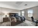 Bedroom with carpet flooring, large windows, and a bed with a geometric pattern comforter at 9050 W Tropicana Ave # 1080, Las Vegas, NV 89147