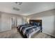 Bedroom featuring carpet, a wooden bed frame, and windows that let in natural light at 9050 W Tropicana Ave # 1080, Las Vegas, NV 89147