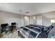 Bedroom with carpet, black desk and monitors, overhead lights, and a bed with a geometric pattern comforter at 9050 W Tropicana Ave # 1080, Las Vegas, NV 89147