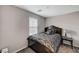 Cozy bedroom with a queen-sized bed, side table, and a window for natural light at 9050 W Tropicana Ave # 1080, Las Vegas, NV 89147