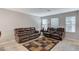 Spacious living room featuring comfortable leather sofas and ample natural light at 9050 W Tropicana Ave # 1080, Las Vegas, NV 89147