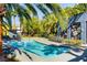 Inviting community pool surrounded by lush palm trees and lounge chairs for relaxing in a resort like setting at 9050 W Tropicana Ave # 1080, Las Vegas, NV 89147
