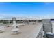 City views from the rooftop, with palm trees, mountains in the distance, and city buildings and equipment at 9050 W Tropicana Ave # 1080, Las Vegas, NV 89147