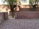Backyard area features a cinder block wall, a gate, and gravel at 10067 Sand Key St, Las Vegas, NV 89178