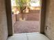 Gated backyard space with rock groundcover, block wall and tree at 10067 Sand Key St, Las Vegas, NV 89178