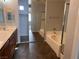 Primary bathroom features dual sinks, separate bathtub, and walk-in shower at 10067 Sand Key St, Las Vegas, NV 89178