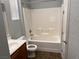 Clean bathroom with a shower-tub combo, single sink vanity, and tile flooring at 10067 Sand Key St, Las Vegas, NV 89178