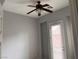 Neutral bedroom with a ceiling fan and natural light from the door window at 10067 Sand Key St, Las Vegas, NV 89178