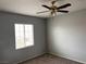 Bedroom with plush carpeting, a ceiling fan, and a bright window at 10067 Sand Key St, Las Vegas, NV 89178