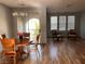 Bright dining area features wood floors and a sliding glass door to the patio at 10067 Sand Key St, Las Vegas, NV 89178