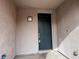 An inviting front entrance with a black door and a decorative light fixture at 10067 Sand Key St, Las Vegas, NV 89178