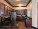 Modern kitchen featuring stainless steel appliances and dark wood cabinets at 10067 Sand Key St, Las Vegas, NV 89178