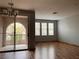 Spacious living room with laminate flooring and sliding glass door to a balcony at 10067 Sand Key St, Las Vegas, NV 89178