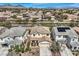 Neighborhood aerial view showcasing tile rooftops, desert landscaping and mountain views in the background at 10808 Wallflower Ave, Las Vegas, NV 89135