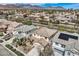 Neighborhood aerial view showcasing tile rooftops, desert landscaping and mountain views in the background at 10808 Wallflower Ave, Las Vegas, NV 89135