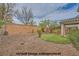 Landscaped backyard with gravel, greenery, and small patch of grass at 10808 Wallflower Ave, Las Vegas, NV 89135
